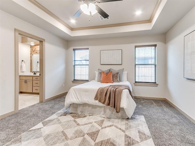 bedroom featuring light carpet, multiple windows, ornamental molding, and a raised ceiling