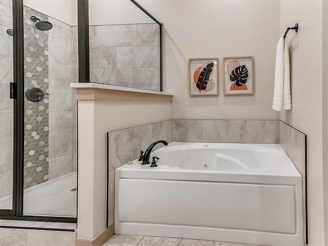 bathroom with a shower stall and a tub with jets