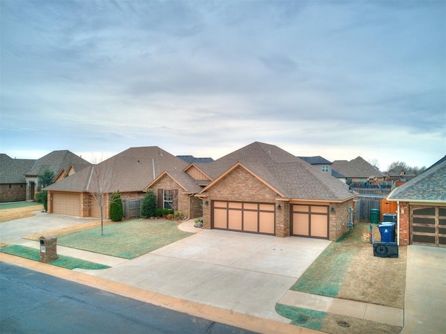 view of front of property with brick siding, roof with shingles, an attached garage, fence, and driveway