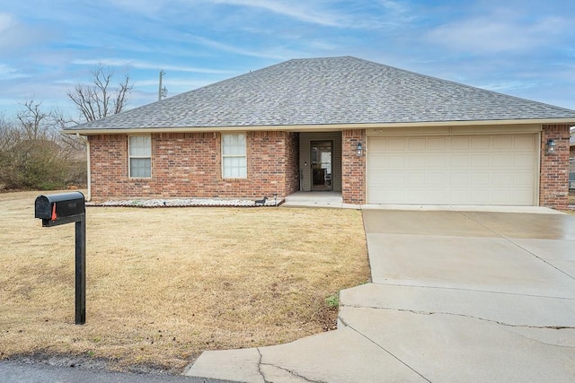 single story home featuring roof with shingles, brick siding, concrete driveway, a garage, and a front lawn