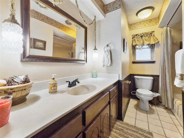 bathroom with tile patterned flooring, curtained shower, toilet, vanity, and a textured ceiling