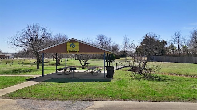 view of property's community with a gazebo, a yard, and fence