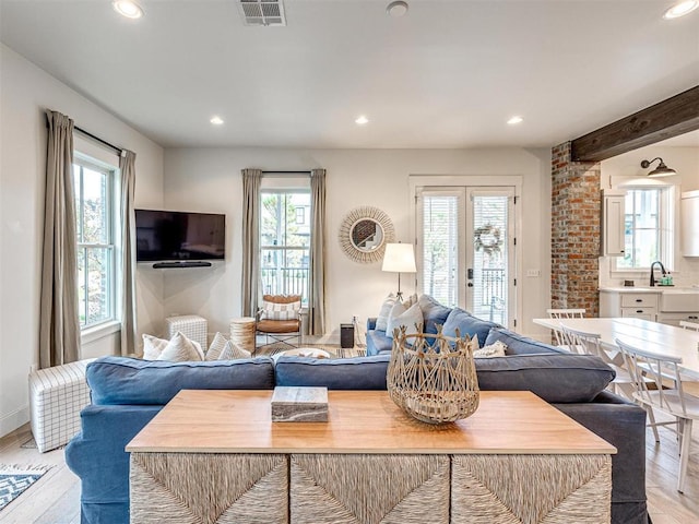 living area featuring recessed lighting, visible vents, and plenty of natural light