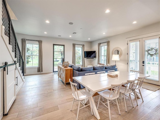 dining room featuring recessed lighting, a healthy amount of sunlight, visible vents, and light wood finished floors