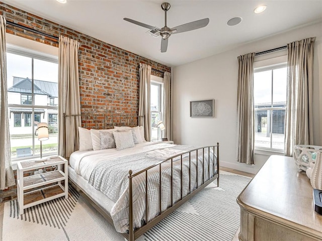 bedroom featuring brick wall, recessed lighting, a ceiling fan, and baseboards