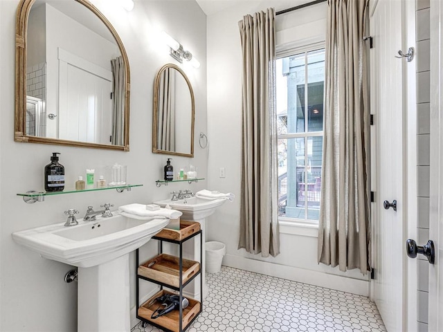 bathroom with plenty of natural light and baseboards