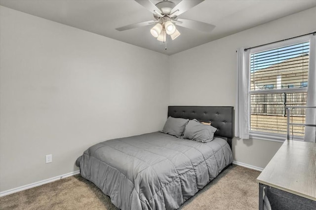 carpeted bedroom featuring a ceiling fan and baseboards