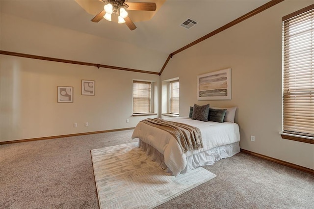 bedroom with visible vents, carpet floors, multiple windows, and vaulted ceiling