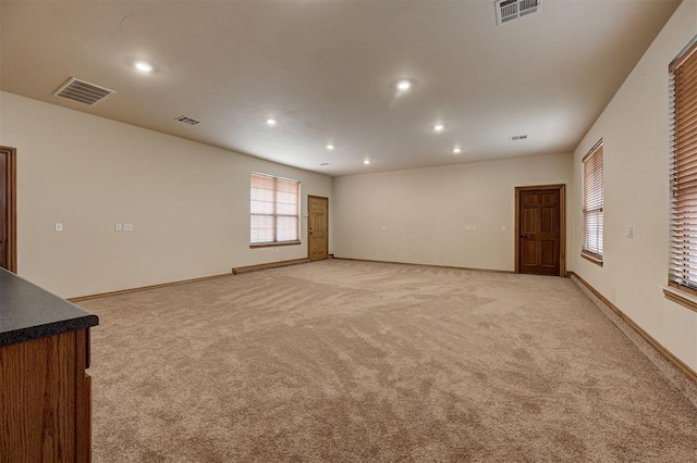 unfurnished room featuring recessed lighting, visible vents, baseboards, and light colored carpet