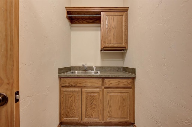 interior space featuring vanity and a textured wall