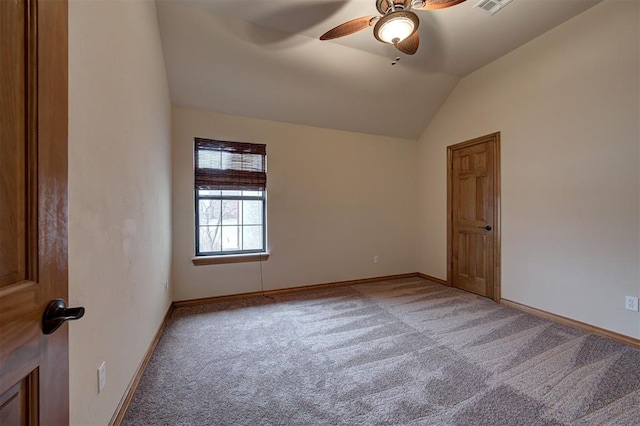 carpeted empty room featuring visible vents, baseboards, ceiling fan, and vaulted ceiling