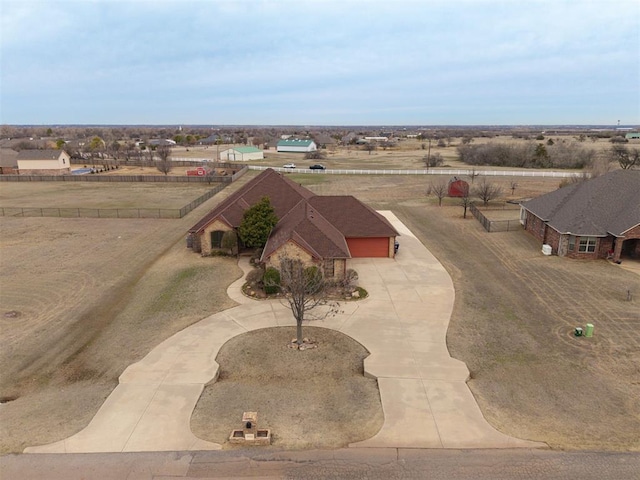 birds eye view of property with a rural view