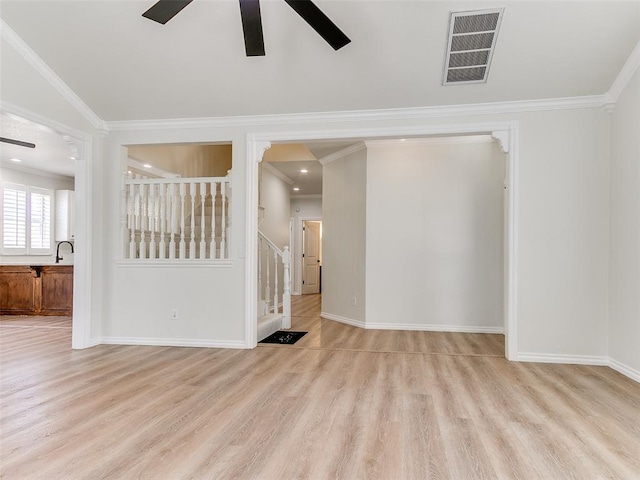 spare room with stairway, ceiling fan, visible vents, and wood finished floors