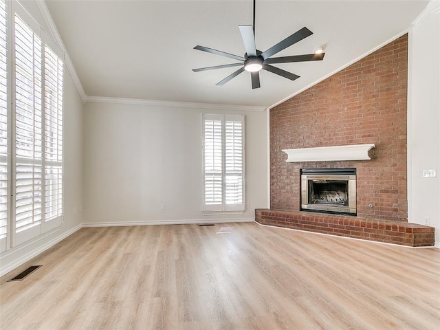 unfurnished living room featuring a fireplace, visible vents, wood finished floors, and ornamental molding