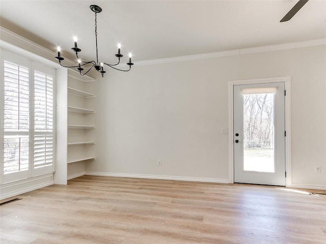 unfurnished dining area featuring light wood finished floors, baseboards, visible vents, and crown molding