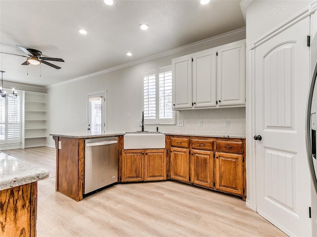 kitchen with light wood-style flooring, a peninsula, a sink, ornamental molding, and dishwasher