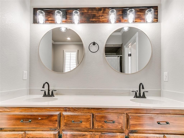 bathroom with double vanity, ornamental molding, and a sink