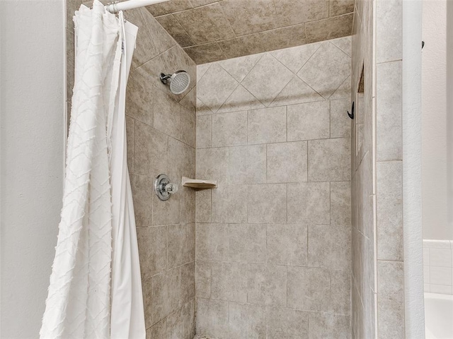 interior details featuring a tile shower