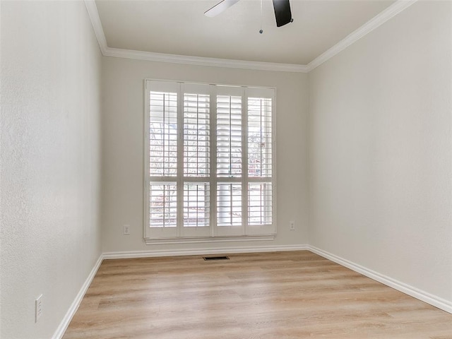 unfurnished room with light wood-type flooring, plenty of natural light, visible vents, and crown molding