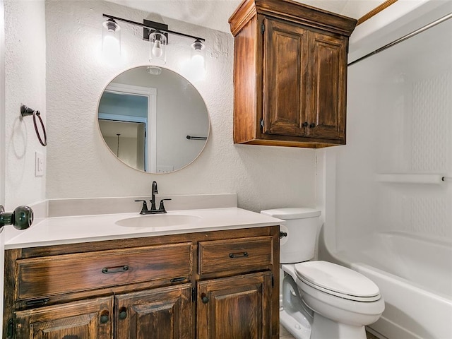 full bathroom featuring a textured wall, vanity, toilet, and shower / bathing tub combination