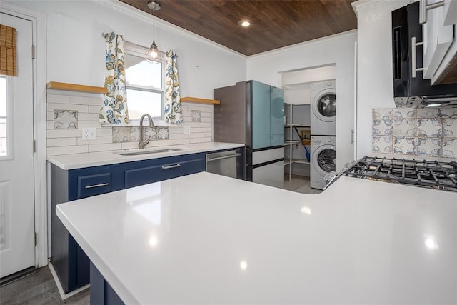 kitchen featuring blue cabinets, stainless steel dishwasher, stacked washing maching and dryer, open shelves, and a sink