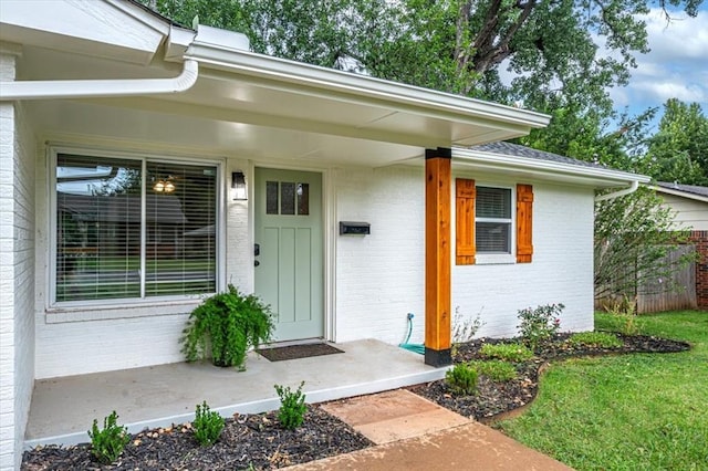 doorway to property featuring brick siding