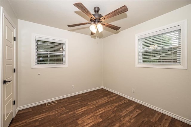 spare room with a ceiling fan, baseboards, visible vents, and wood finished floors