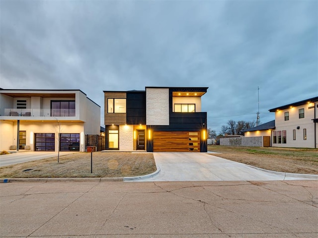 modern home featuring concrete driveway and a garage