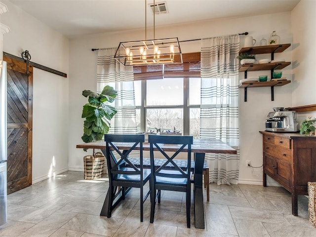 dining space featuring a barn door, baseboards, visible vents, and an inviting chandelier