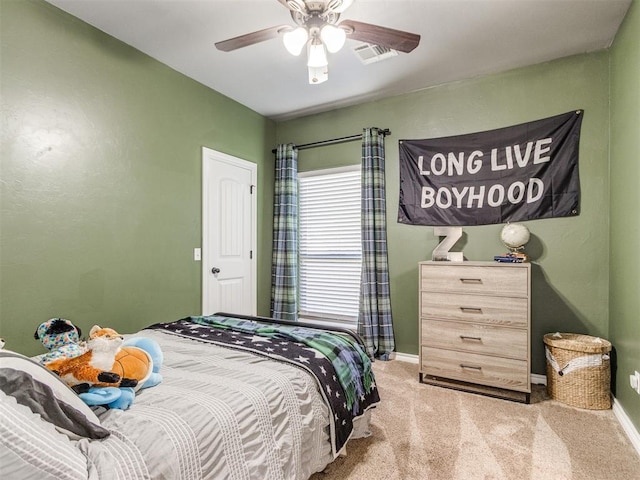 bedroom featuring baseboards, visible vents, carpet floors, and ceiling fan