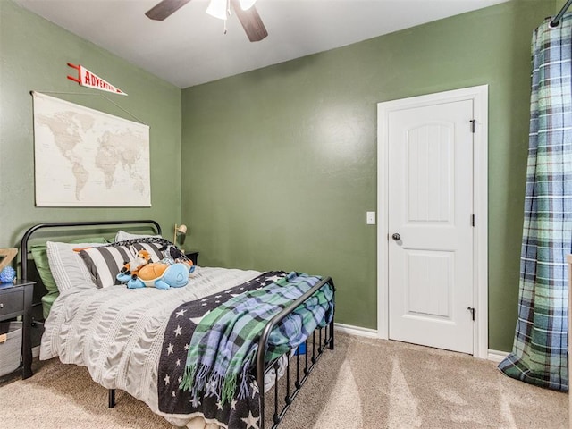 carpeted bedroom with baseboards and ceiling fan