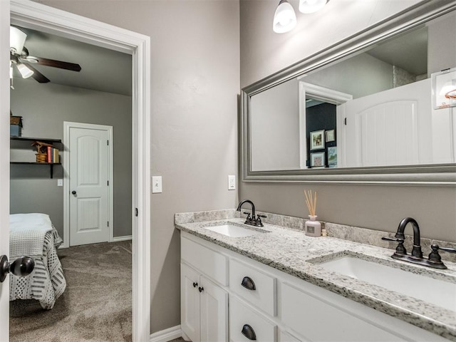 bathroom featuring double vanity, ensuite bathroom, ceiling fan, and a sink