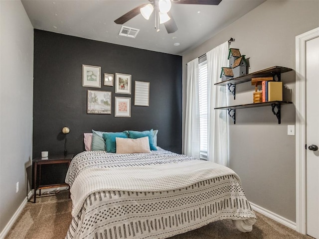 bedroom featuring visible vents, carpet flooring, an accent wall, and baseboards