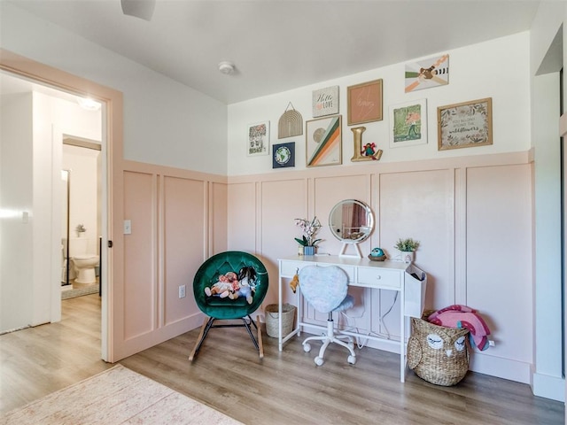 office space with wood finished floors and a decorative wall