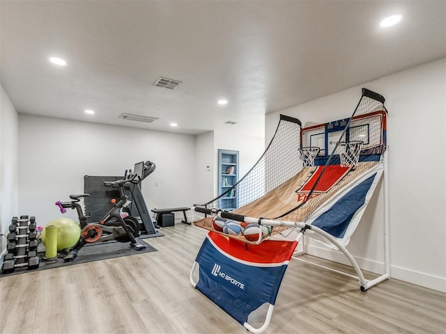 exercise area with recessed lighting, wood finished floors, and visible vents