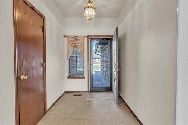 foyer with visible vents, baseboards, and light tile patterned flooring