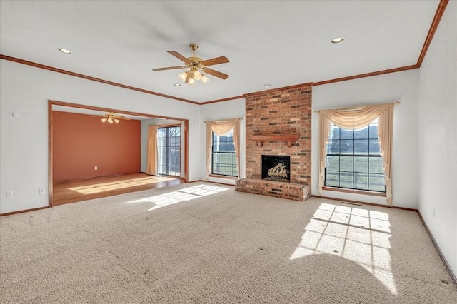 unfurnished living room with a fireplace, carpet flooring, and a healthy amount of sunlight