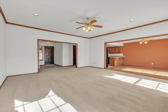 unfurnished living room with light carpet, a ceiling fan, and baseboards