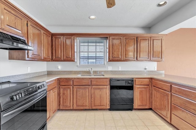 kitchen with black appliances, under cabinet range hood, brown cabinetry, and a sink