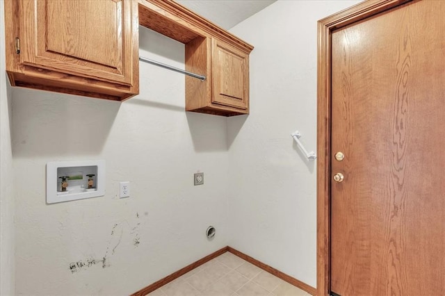 clothes washing area with washer hookup, cabinet space, and baseboards