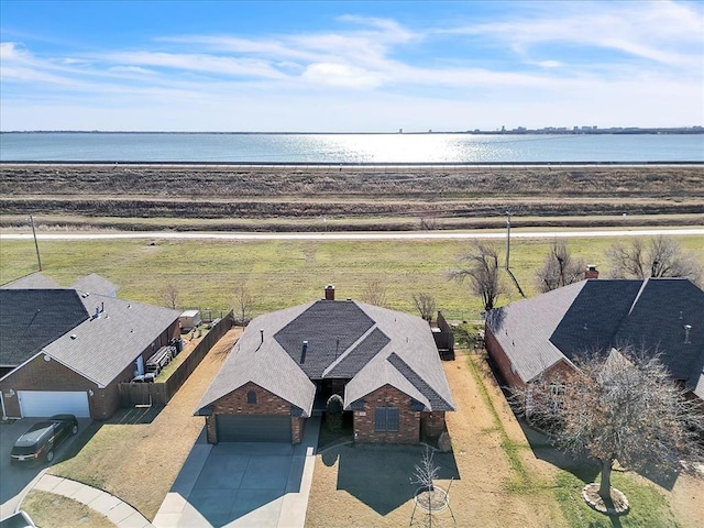 birds eye view of property with a water view