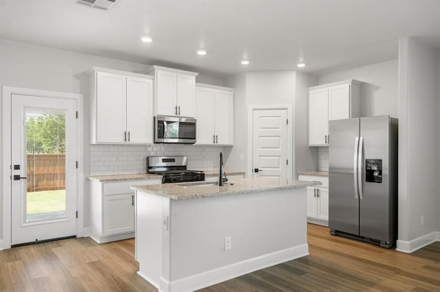 kitchen with appliances with stainless steel finishes and white cabinets