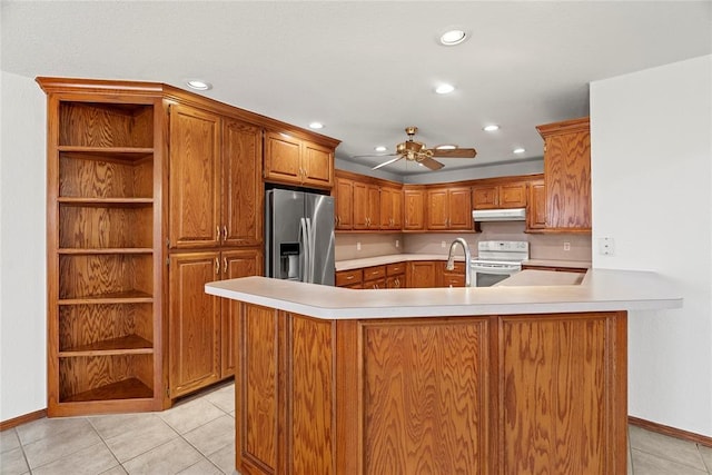 kitchen featuring stainless steel refrigerator with ice dispenser, light tile patterned floors, white range with electric cooktop, light countertops, and under cabinet range hood