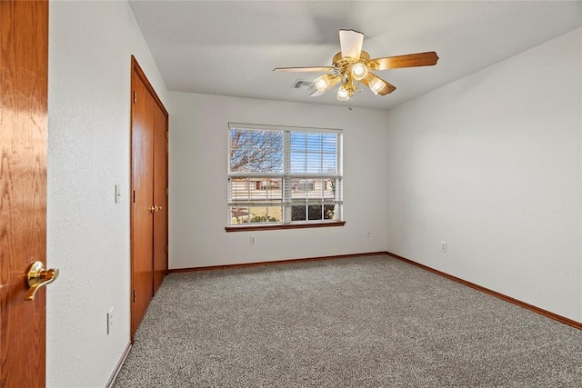 unfurnished bedroom with carpet, a closet, visible vents, ceiling fan, and baseboards