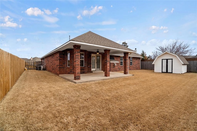 back of house with a patio area, french doors, brick siding, and a fenced backyard