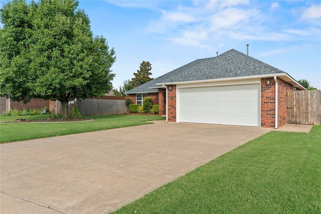 501 N Cherokee Way, Mustang, OK 73064 - view of property exterior with an attached garage, brick siding, driveway, and a shingled roof