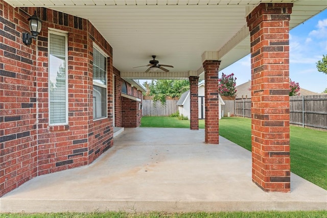 501 N Cherokee Way, Mustang, OK 73064 - fenced backyard featuring ceiling fan, a patio area, and an outbuilding