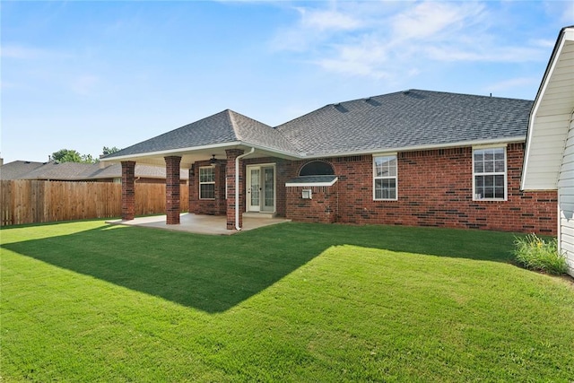 501 N Cherokee Way, Mustang, OK 73064 - rear view of property featuring a shingled roof, a patio, brick siding, and a ceiling fan