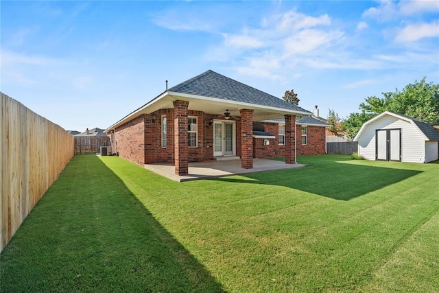 501 N Cherokee Way, Mustang, OK 73064 - back of property with a storage unit, a fenced backyard, and brick siding