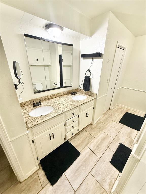 bathroom with double vanity and a sink